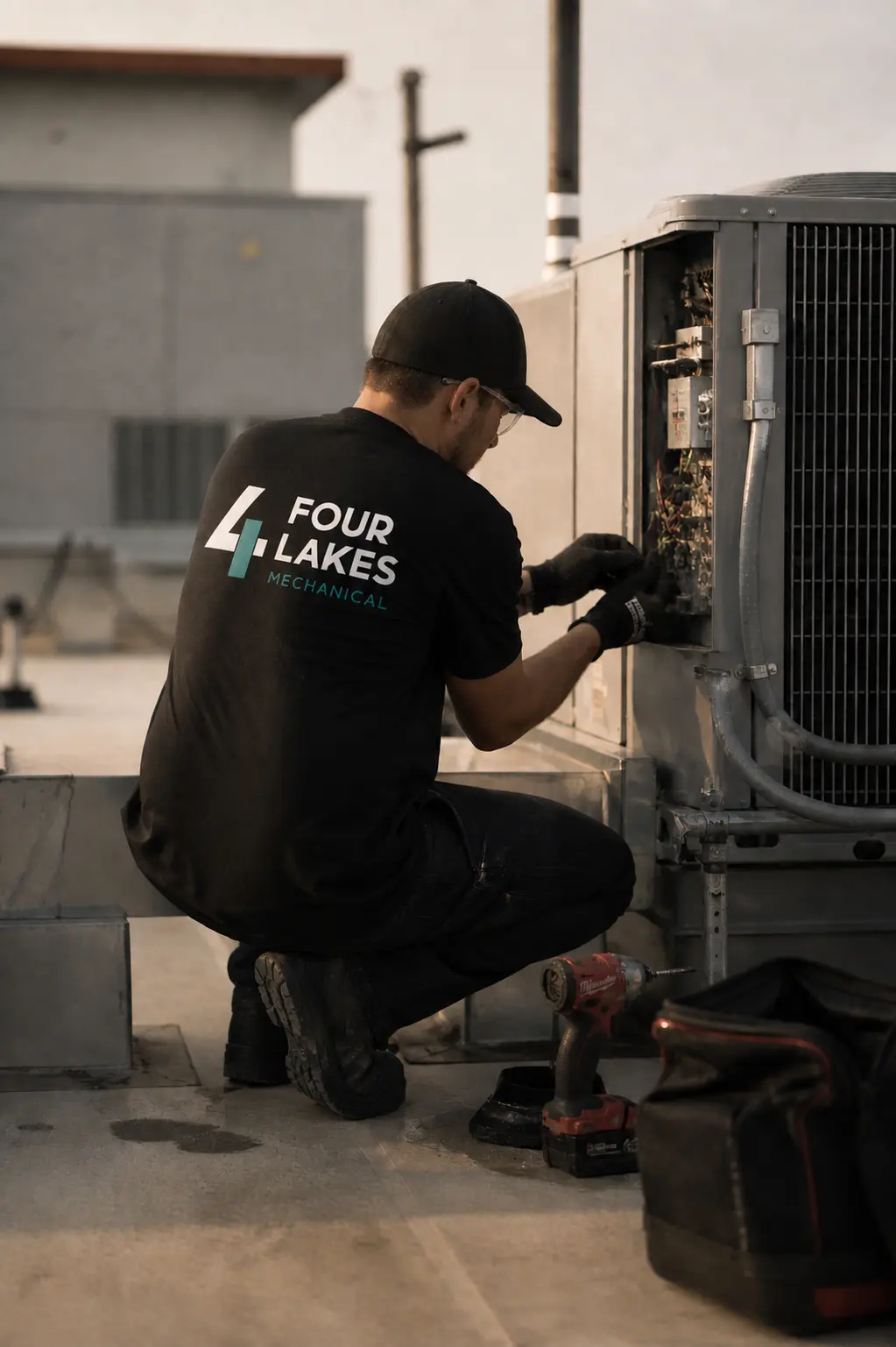 HVAC technician working on rooftop unit